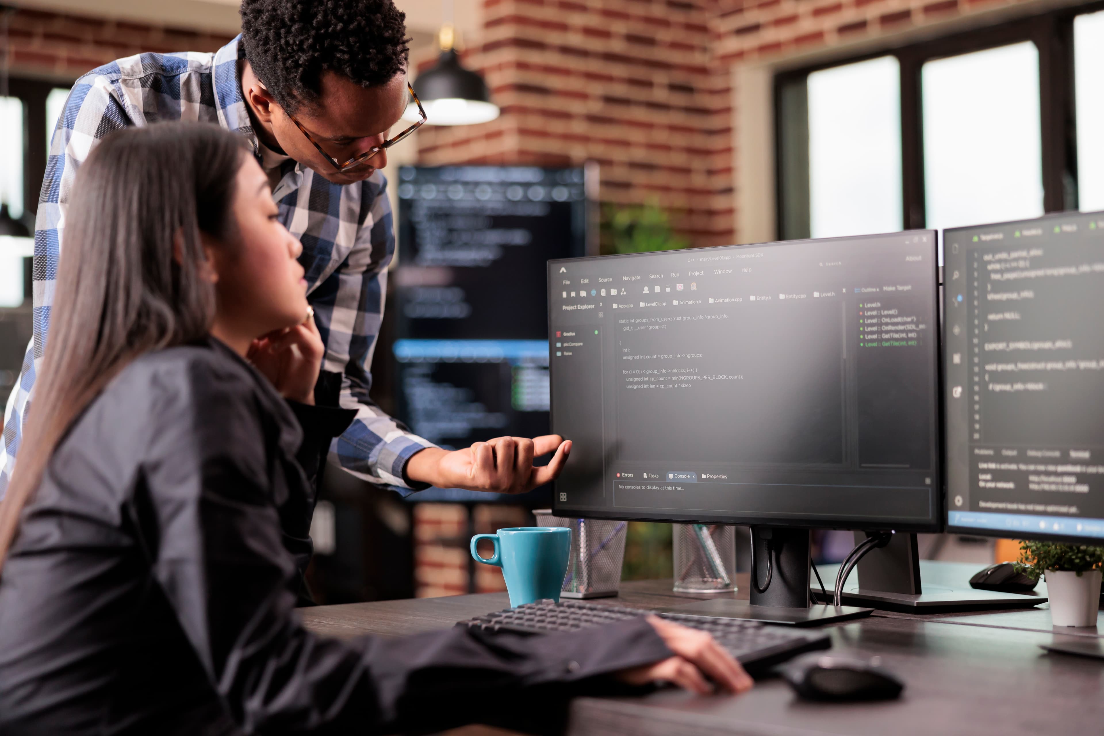 Tilted development interface with code panels and UI wireframes